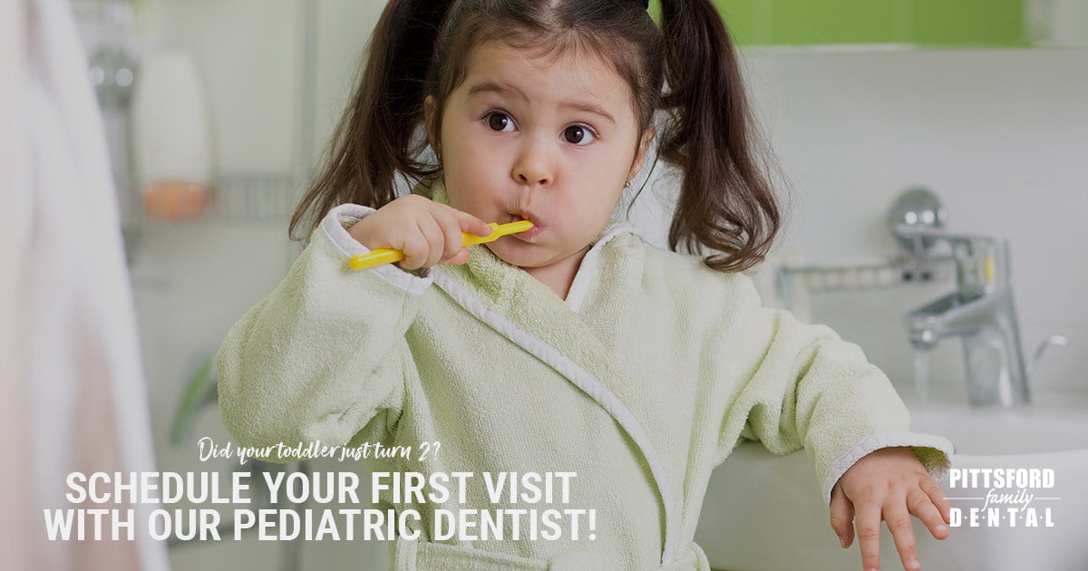 Toddler brushing teeth in bathroom with text promoting pediatric dental services at Pittsford Family Dental.