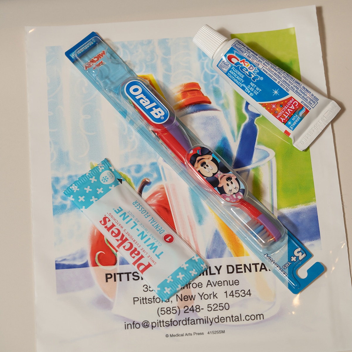Dental care products featuring Finding Nemo characters on Pittsford Family Dental promotional material.