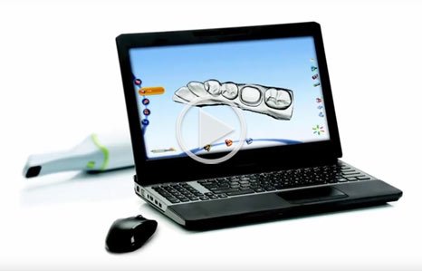 Laptop displaying dental design software with mouse and stylus pen on white background.