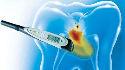 Digital thermometer showing fever against translucent blue tooth illustration with heat visualization.