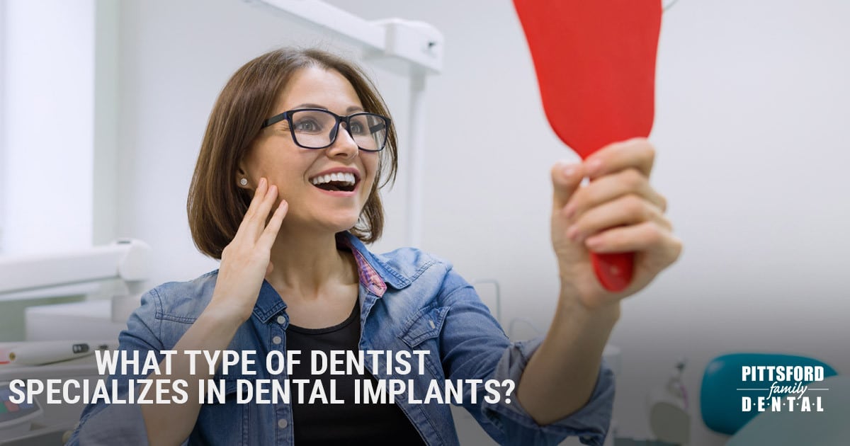 Woman in dental office holding red card, smiling with text about dental implant specialists.