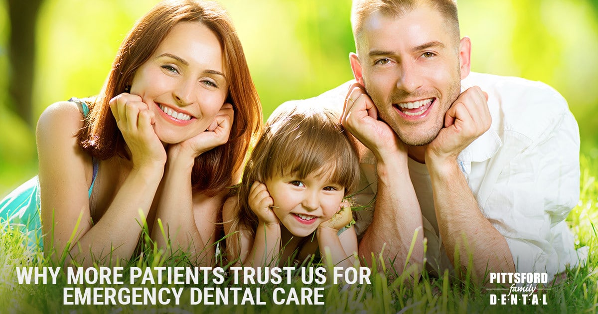Happy family of three smiling outdoors on grass with Pittsford Family Dental branding.